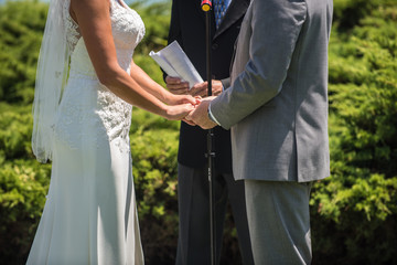 Man and woman at alter with officiate to say their vows in the wedding ceremony.