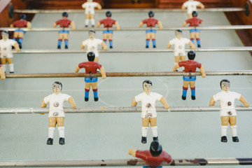 dolls of a retro foosball table to play table football