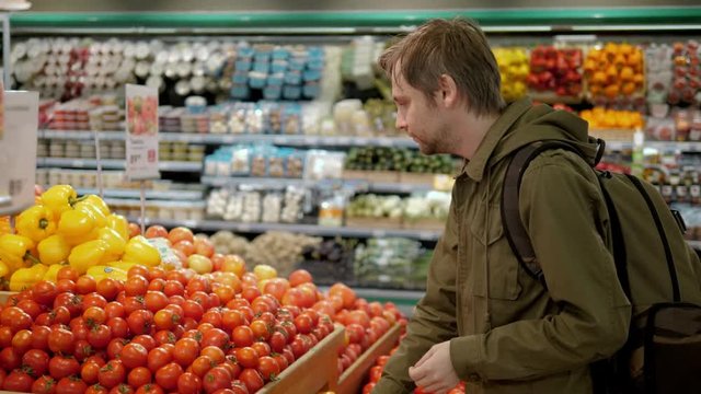 Young man shopping tomato food in vegetable store or supermarket tourist healthy
