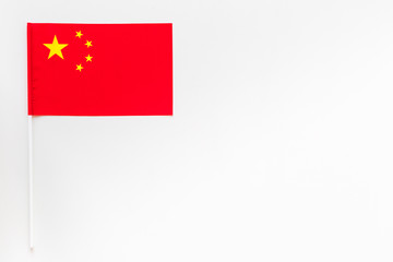 Chinese flag concept. small flag on white background top view copy space