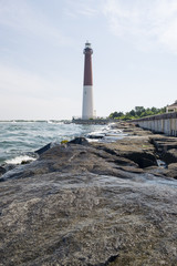Fototapeta na wymiar lighthouse in New Jersey provides warning light on island for ships navigating through ocean channels