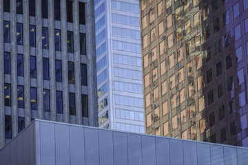 Walls of skyscrapers facades in Toronto in a daylight with reflections