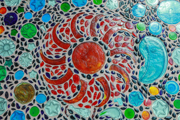 Colorful Floral Mosaic Design of Red Blue and Turquoise Glass Tiles on the Floor