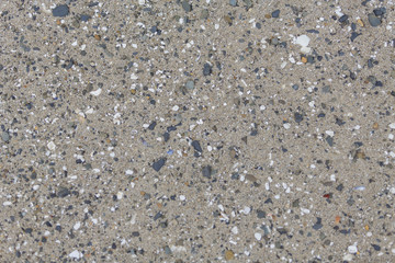 Beach sand with pebbles texture.