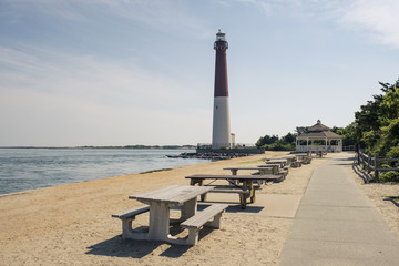lighthouse in New Jersey provides warning light on island for ships navigating through ocean channels