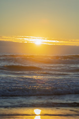 Golden sunset on ocean. Pacific ocean. Waves in ocean.