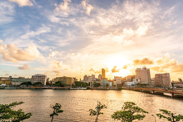 Fototapeta premium Sunset at Capibaribe River (Rio Capibaribe), Alfandega Bund (Cais da Alfândega), Recife, Pernambuco, Brazil