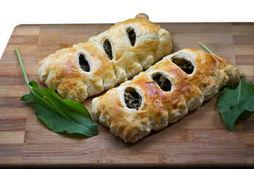 Buns of puff pastry with sorrel close-up. Tasty homemade cakes with greens