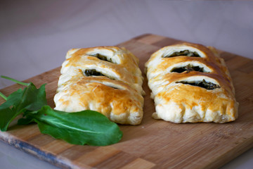 Buns of puff pastry with sorrel close-up. Tasty homemade cakes with greens