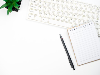 Modern white office desk table with keyboard computer and other office supplies of necessity, Top view with copy space