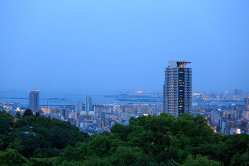 Blue sky meets blue water on the edge of downtown Kobe at dusk