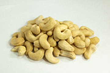 cashew nuts heap , yellow color beans on white background