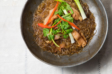 casserole becon with glass noodles in pan on white table