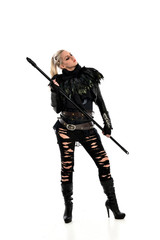 full length portrait of blonde girl wearing black gothic outfit, holding a staff. standing pose, isolated on white studio background.