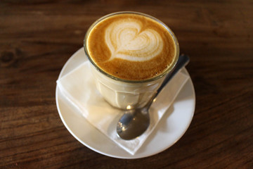 A cup of hot cafe latte (plus its latte art)