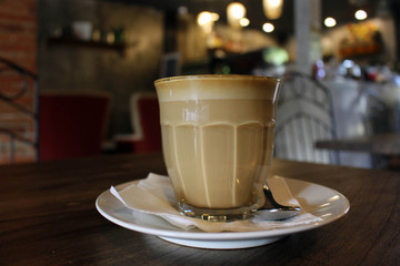 A cup of hot cafe latte (plus its latte art)