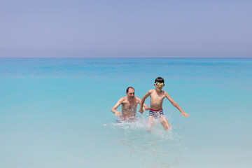 Father and son at Ionian Sea, Egremni beach, Lefkada Greece