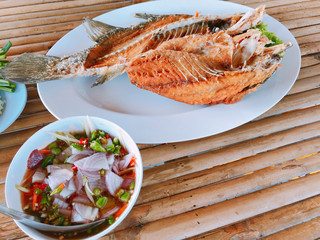 Thai style Deep Fried Sea Bass served with Spicy Green Mango Salad.
