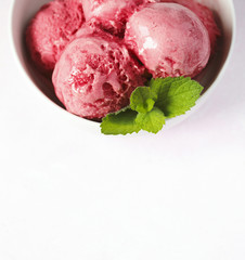 Raspberry ice cream in white bowl