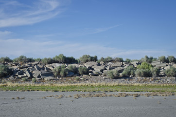 A landscape view of the old concrete and dry sand along the great salt lake walk way. 