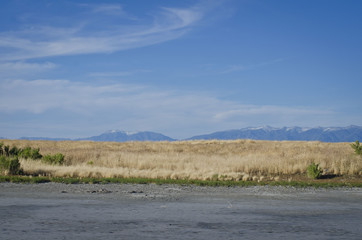 A landscape view of the field and sand of the great salt lake in utah. 