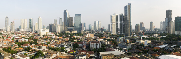 Stunning panorama of Jakarta South Central Business district contrasting with low rise residential middle class housing area in Indonesia capital city in Southeast Asia