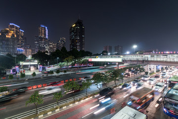 Rush hour captured with blurred motion in the heart of the business district of Jakarta on the gatot Subroto highway in Indonesia capital city at night