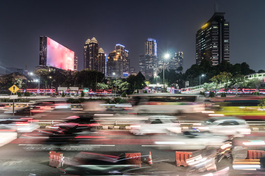 Rush hour captured with blurred motion in the heart of the business district of Jakarta on the gatot Subroto highway in Indonesia capital city at night