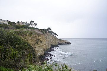 The long out crop of the la jolla state beach cliffs on a overcast day. 