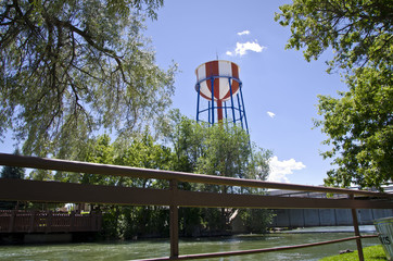 A view of the classic red, white and blue water tower in the idaho sun. 