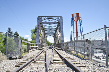 Fototapeta premium The long bridge and colorful water tower in the hot idaho falls sun. 