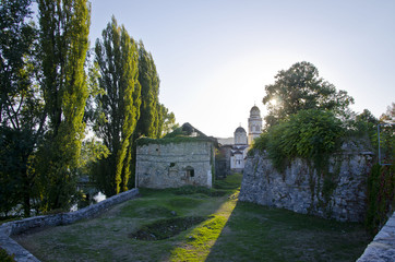 A view of the sunlight coming through the church buildings in the bosnian countryside. 