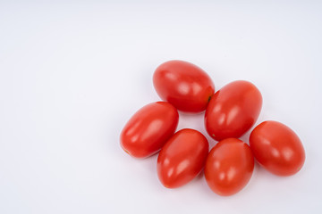 Close up of Fresh Cherry tomatoes isolated on white background with natural shadow. Top view.