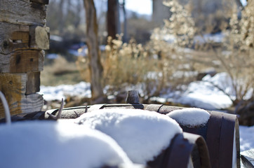 The snow covered barrels in the old wild west post office. 