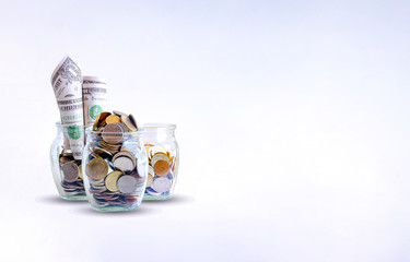 The coins in bottle on white background. save money for future. The concept of growth for the save money.