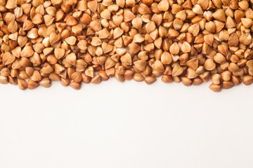 Raw buckwheat on white background