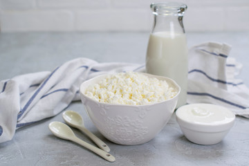 Organic Farming Cottage cheese, curd in a white ceramic  bowl, sour cream and milk in a bottle