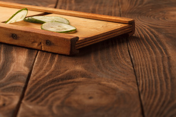 Fresh cucumber, chopped cucumber, isolated on wooden board