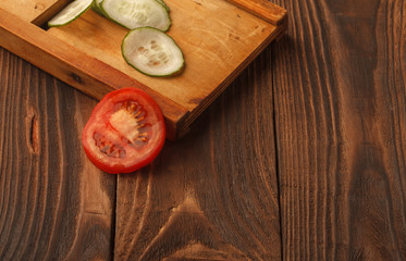 Closeup Of Young Woman In Kitchen Cutting Vegetables