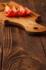 Fresh tomato halves on the wooden table
