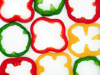 Fresh vegetables, red, yellow, green sweet peppers on white background.