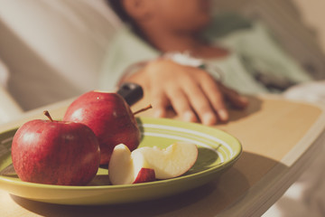  closeup of red apples in the plate  for the patient in the hospital bed.