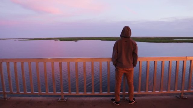 Enjoying nature while leaning on railing at Lake Okeechobee