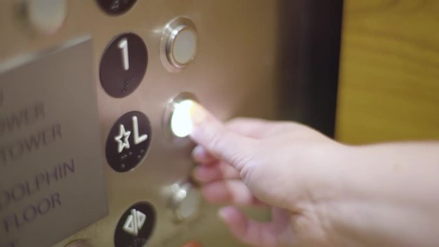 Woman Presses L For Lobby In Hotel Elevator (Slow Motion)
