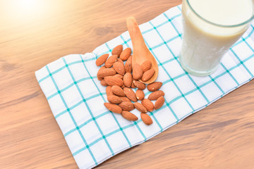 Close-Up View of Almonds on Table Napkin with Almond Milk