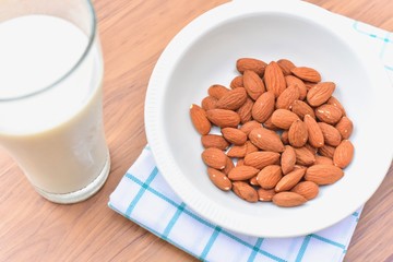 Close-Up View of Almonds in a Bowl and a Glass of Healthy Almond Milk