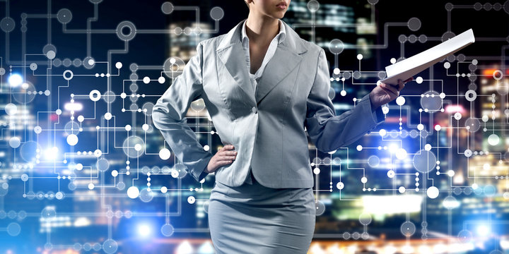 Close of businesswoman against night cityscape background and technology concept