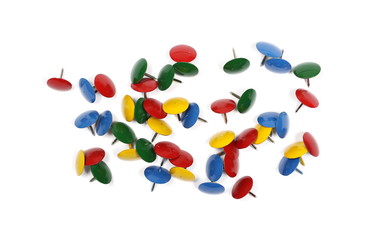 Various colorful metal pushpins pile isolated on white