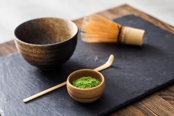 green matcha tea prepearing on stone black table 