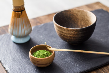 green matcha tea prepearing on stone black table 